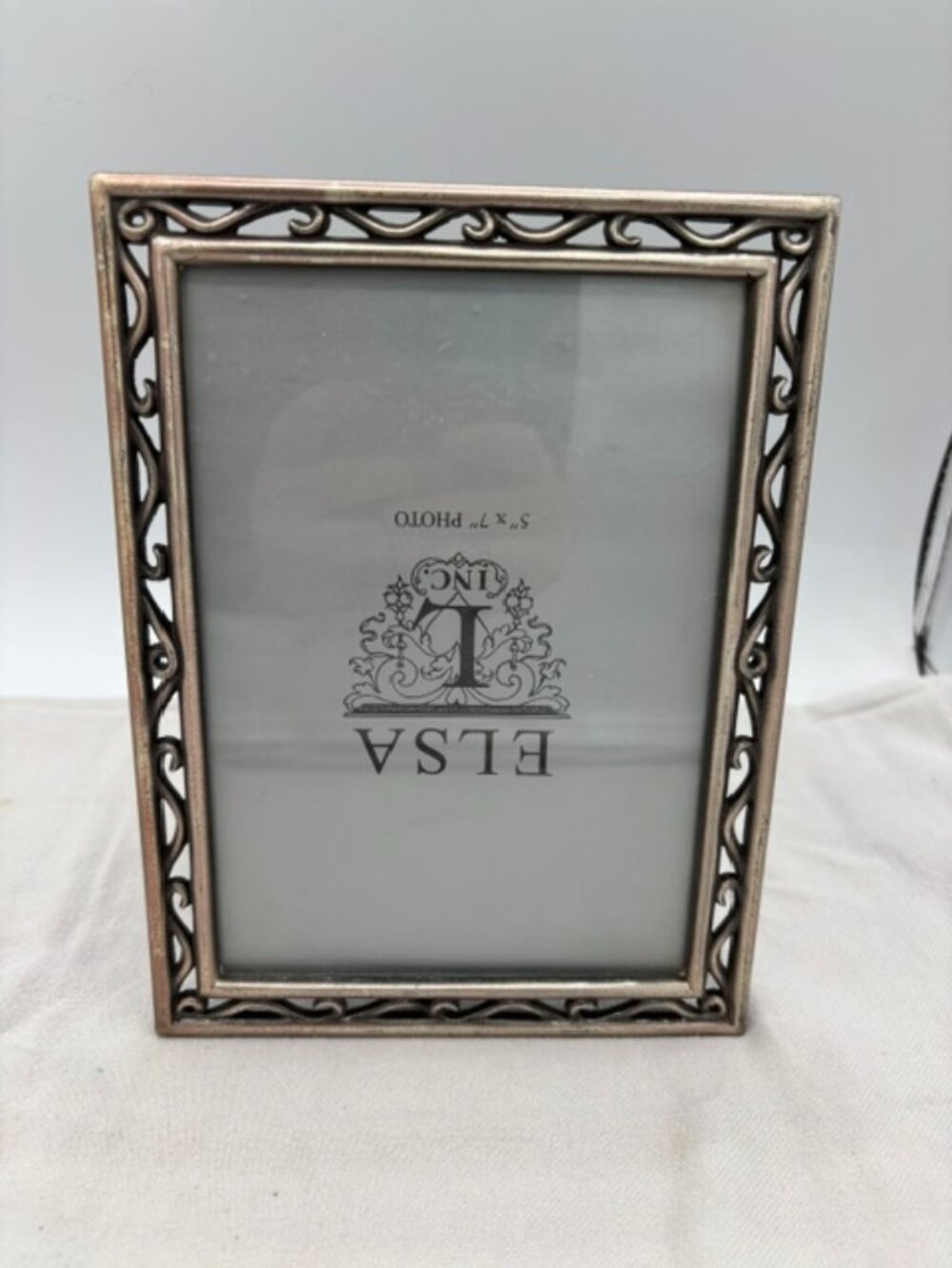 Elsa L. Inc. 5" X 7" Silver frame.